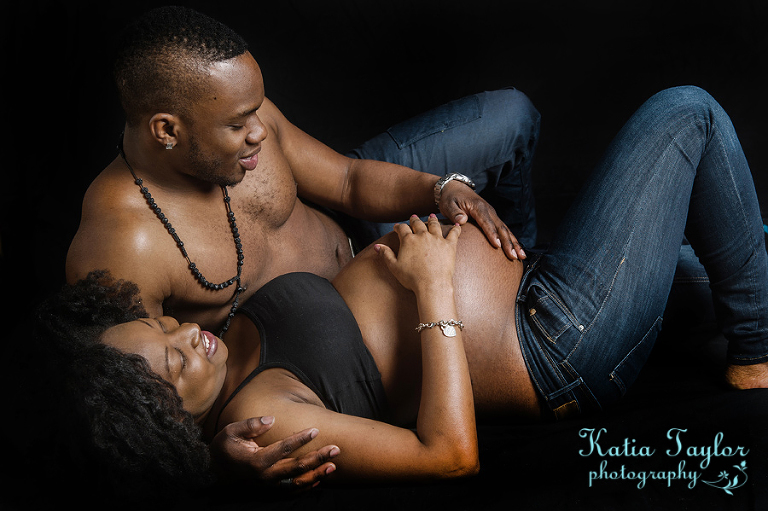 Maternity image of couple relaxing with baby bump