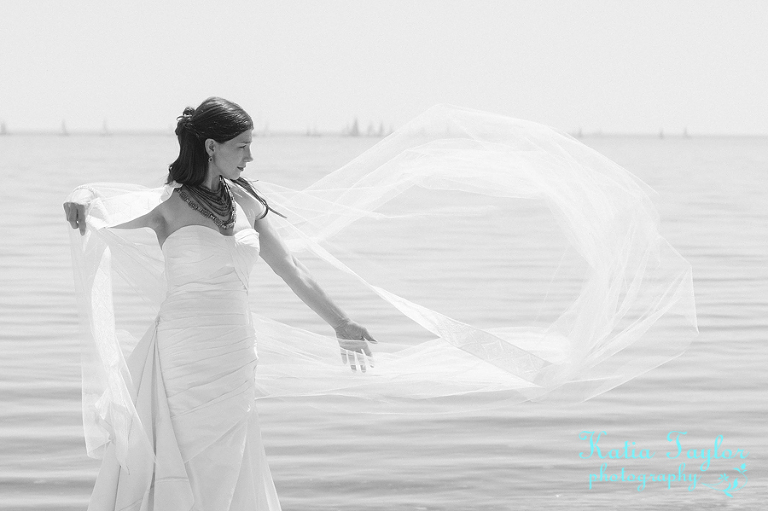 Bride with flowing veil on the beach