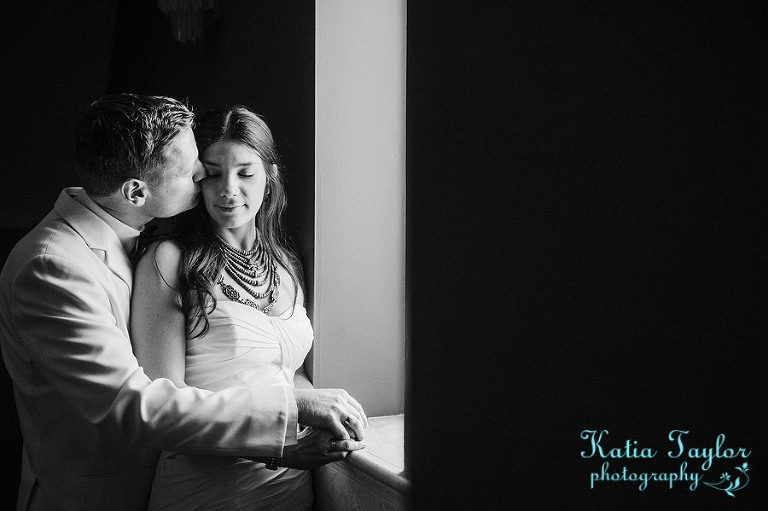 Elegant black and white portrait of bride and groom in window light