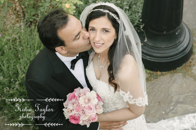 Groom kisses bride on the cheek in overhead shot