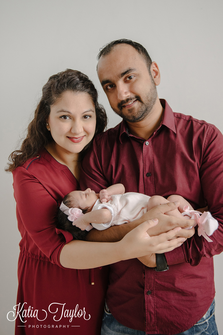 New parents hold their baby girl