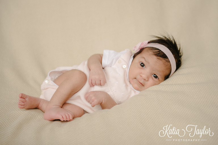 Little newborn baby girl laying on a blanket