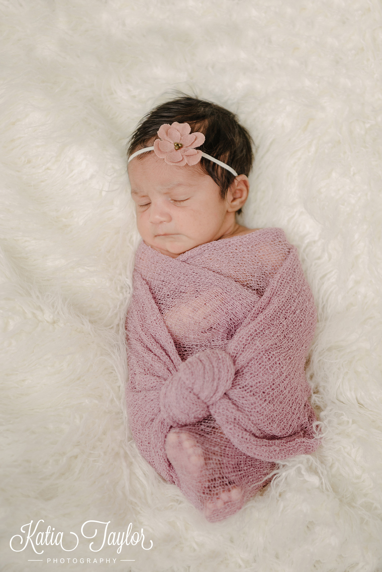 Sleeping newborn baby girl on a fluffy blanket