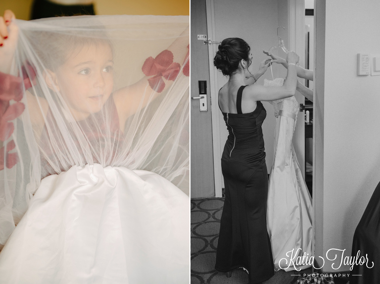 Flower girl peeks through her dress while maid of honor hands bride her dress. Toronto wedding photography.