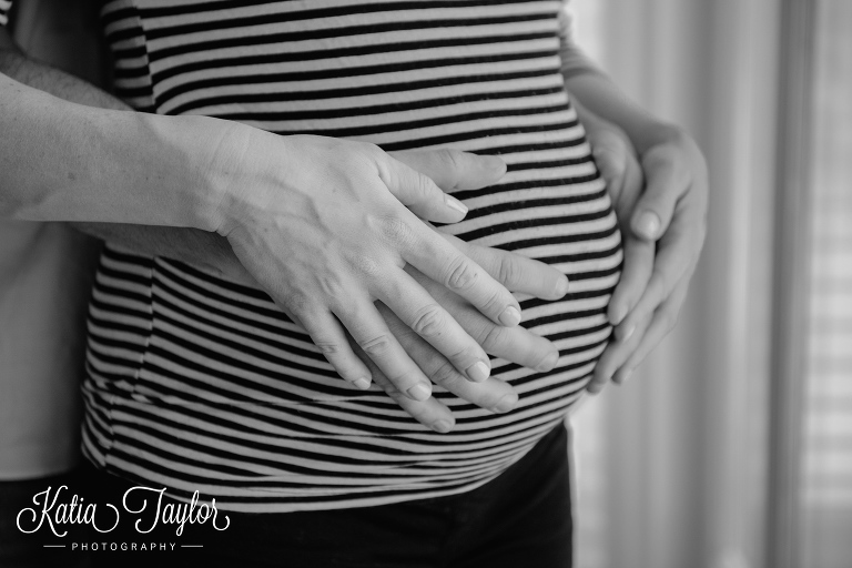 Close-up of baby bump with parents hands. Toronto lifestyle maternity portraits. 