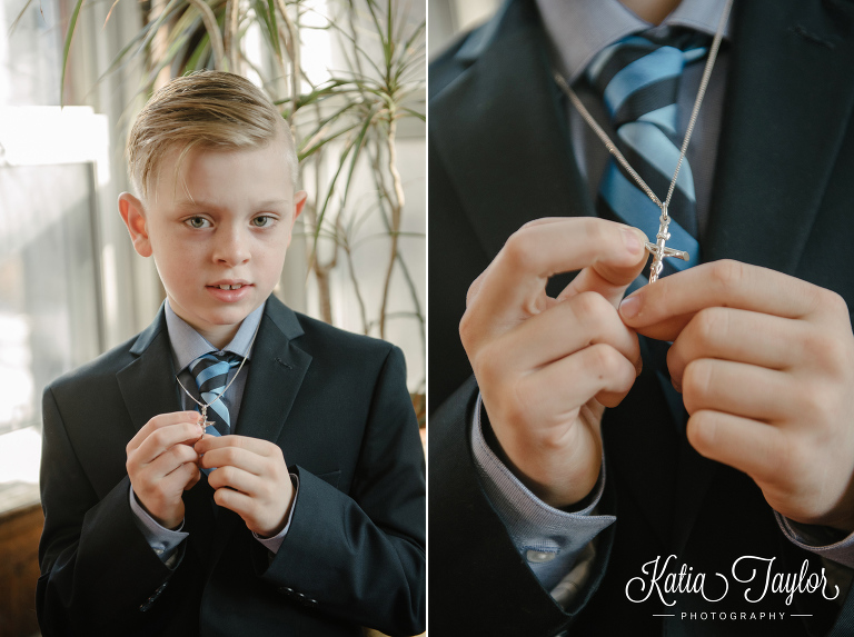 First communion. Toronto. Boy holding his cross necklace.