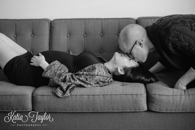 Husband kisses pregnant wife on the forehead. Toronto maternity portraits.