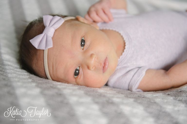 Cute newborn girl with lilac headband. Toronto newborn photographer. www.katiataylorphotography.com