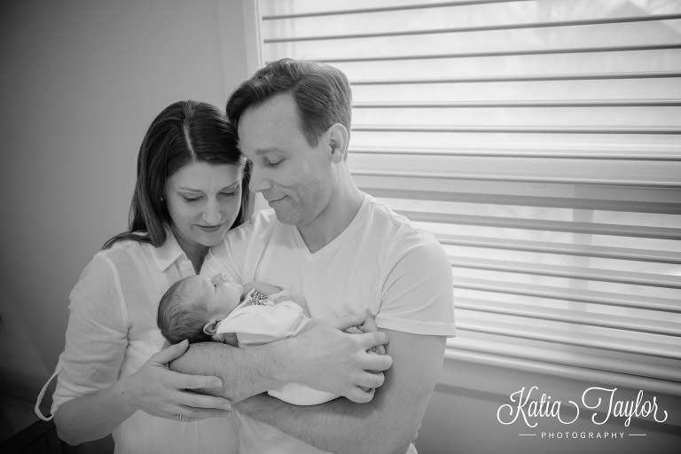 New parents cuddle their baby boy. Toronto lifestyle newborn photos. www.katiataylorphotography.com