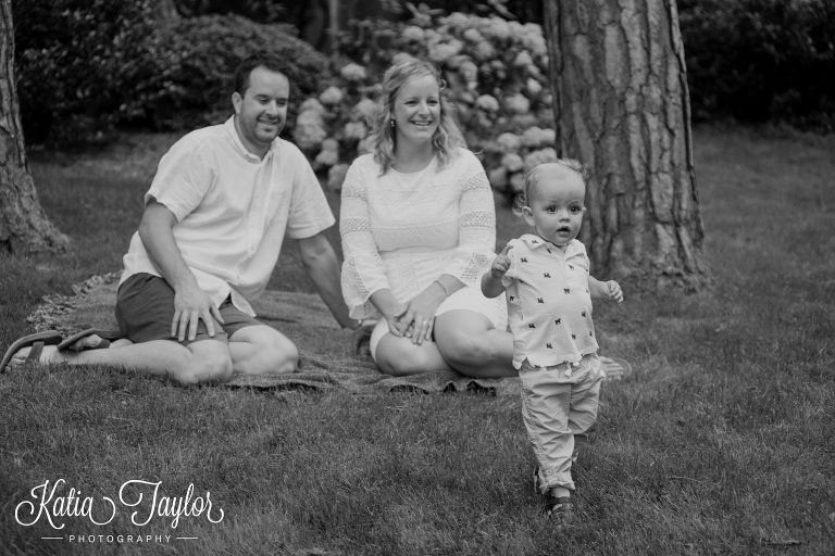 Parents watch their son explore the park. Toronto Family Photography. Brueckner Rhododendron Park