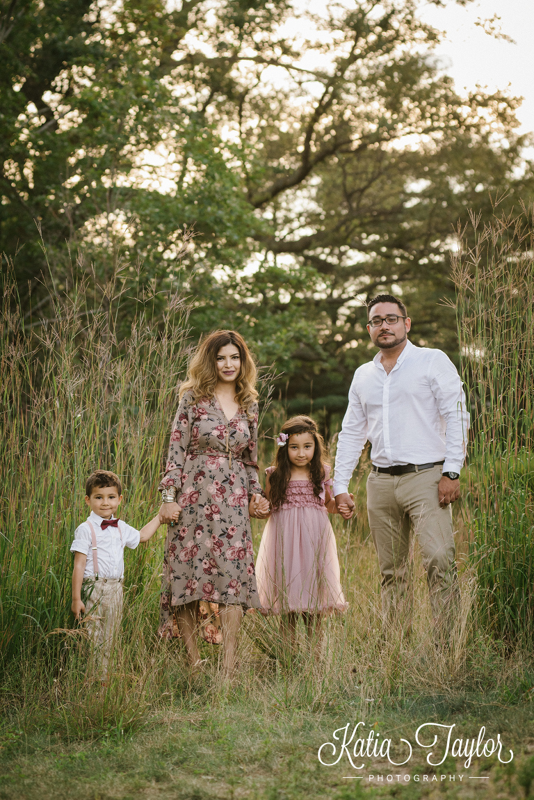 Family hold hands in the park. Toronto family portraits in High Park. 