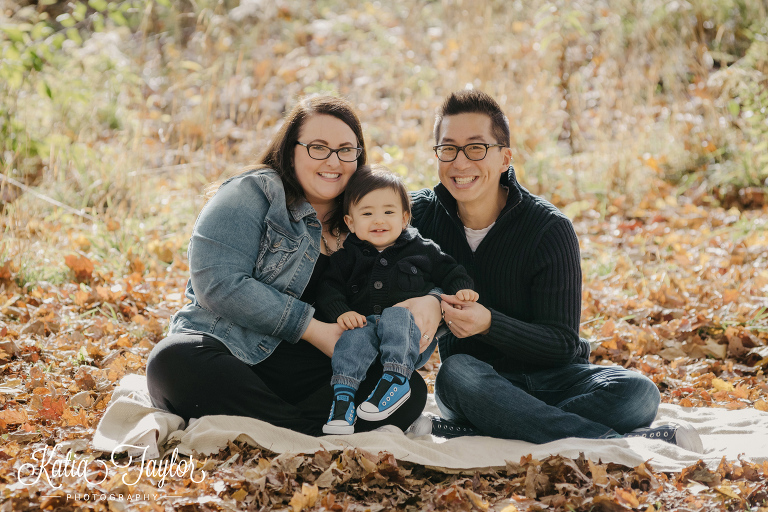 Family of 3 in the Fall leaves. Toronto High Park Fall family portraits.