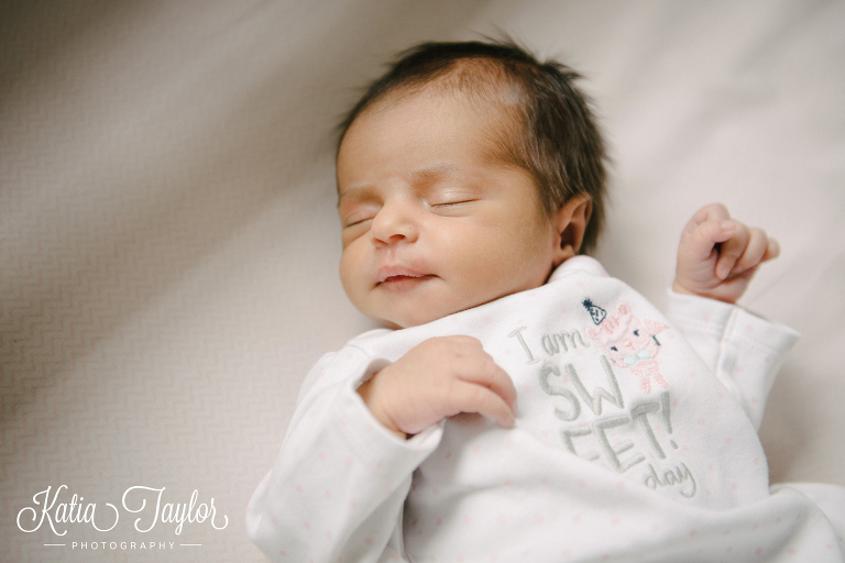 Newborn baby girl sleeping in her crib. Toronto lifestyle newborn portraits.