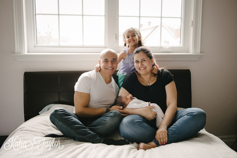 Parents and big sister with newborn baby. Toronto lifestyle newborn portraits.