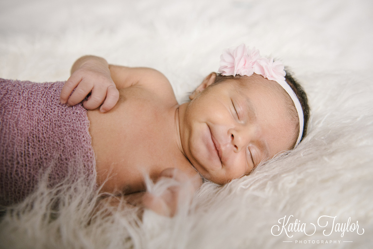 Smiling newborn baby girl. Toronto lifestyle newborn portraits.