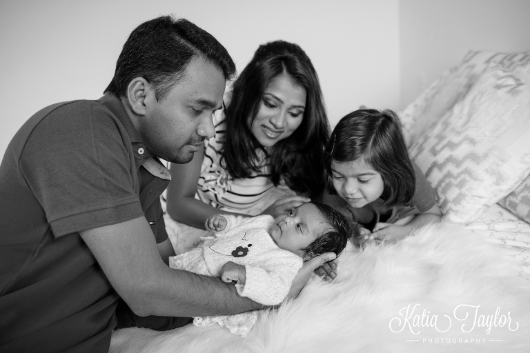 Lifestyle family portraits with 2-month-old baby and older daughter.