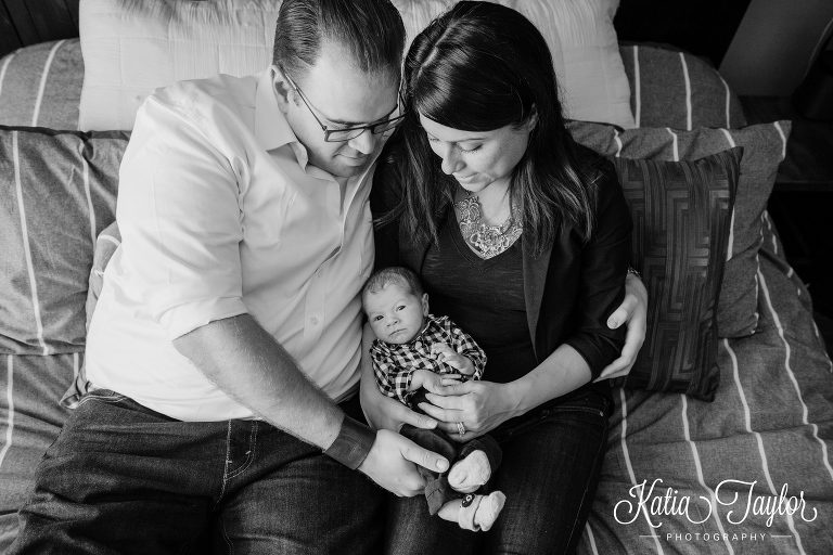 Cute little newborn baby boy with his parents. Toronto lifestyle newborn photo shoot at home.