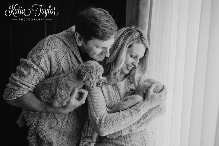 New parents and their toy poodle cuddle newborn baby boy. Toronto newborn photos.