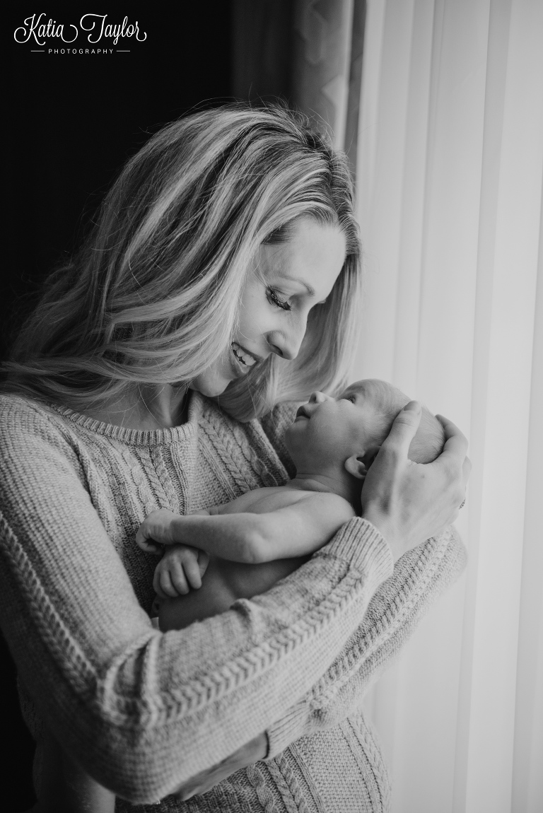 New mother smiles at her baby boy. Toronto newborn photos.