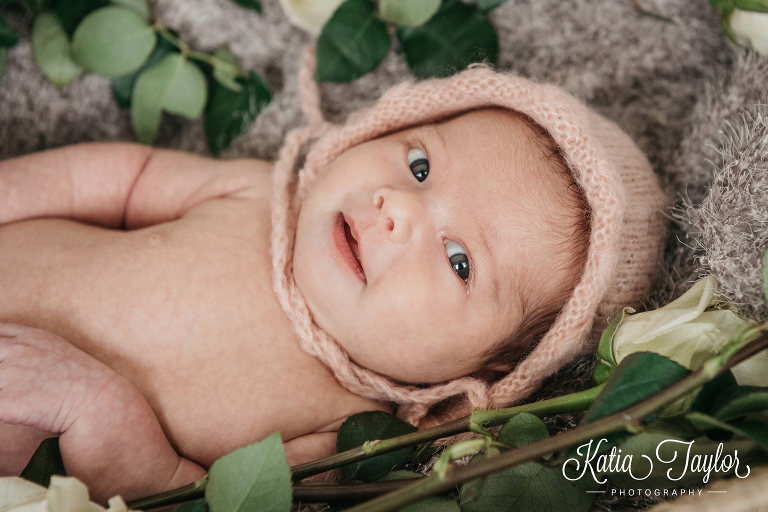 Nwebornbaby girl in light pink knit bonnet. Toronto newborn photography.