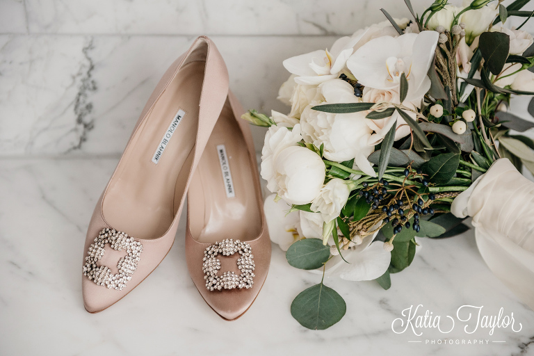 Bride's Manolo Blahnik wedding shoes and white flower bouquet. Toronto wedding photographer. Shangri-La Hotel wedding.