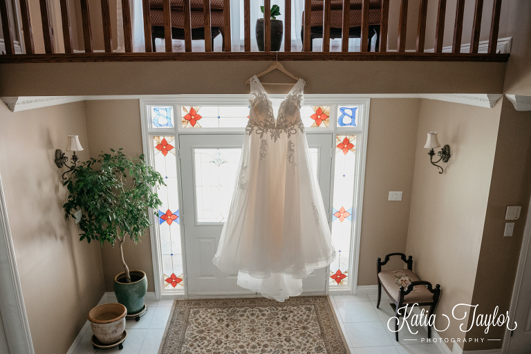 Wedding dress hanging from a balcony. Toronto wedding photography.
