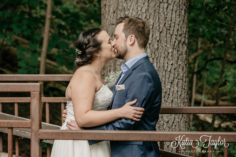 Bride and groom kissing in High Park. Toronto Wedding Photography.