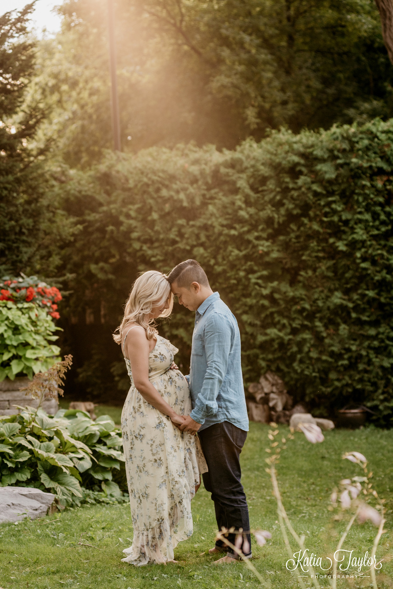 Golden sunset maternity portrait of expectant couple outside. Toronto maternity photography.