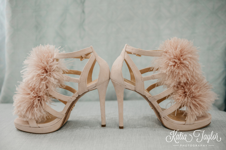 Super fun and funky blush wedding shoes with feather pom-poms.