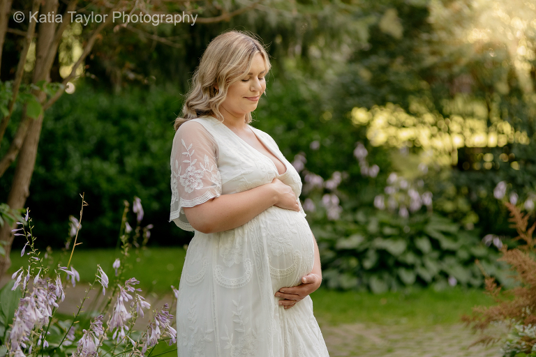 Pregnant woman in flowing white gown at James Gardens, Toronto
