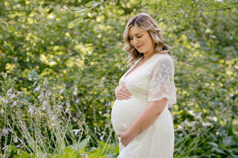 Pregnant woman in flowing white gown at James Gardens, Toronto