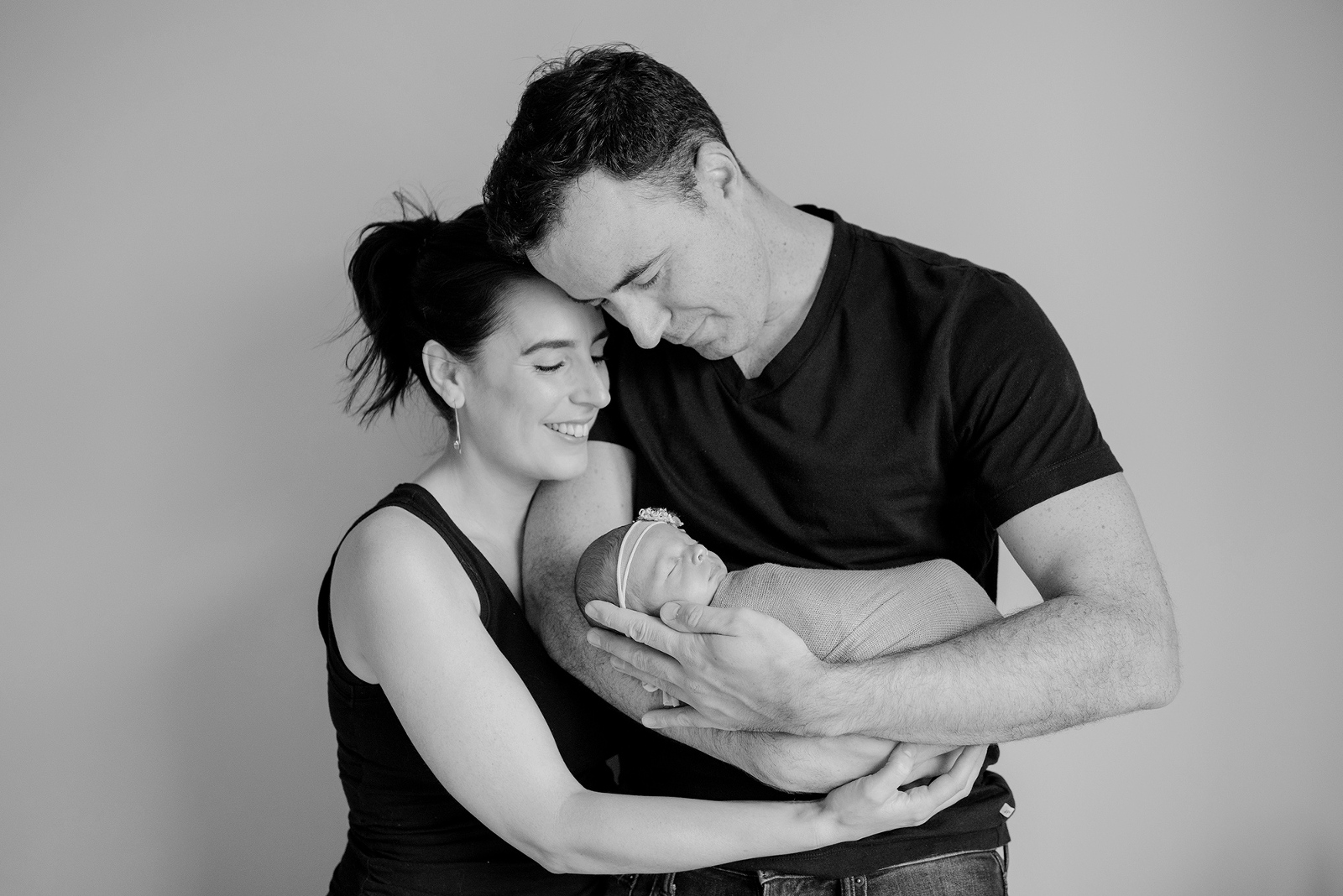 Parents holding their newborn baby girl in Toronto
