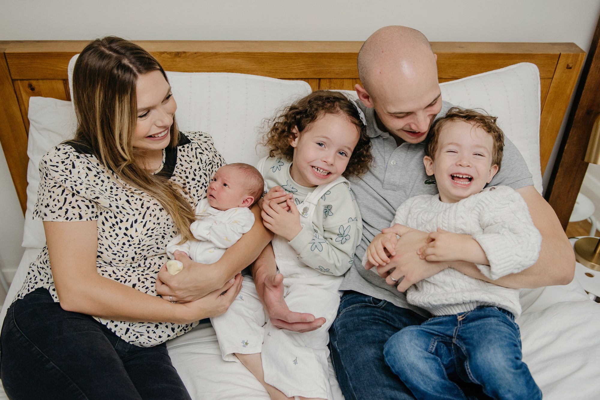Husband and wife with their two children and one newborn